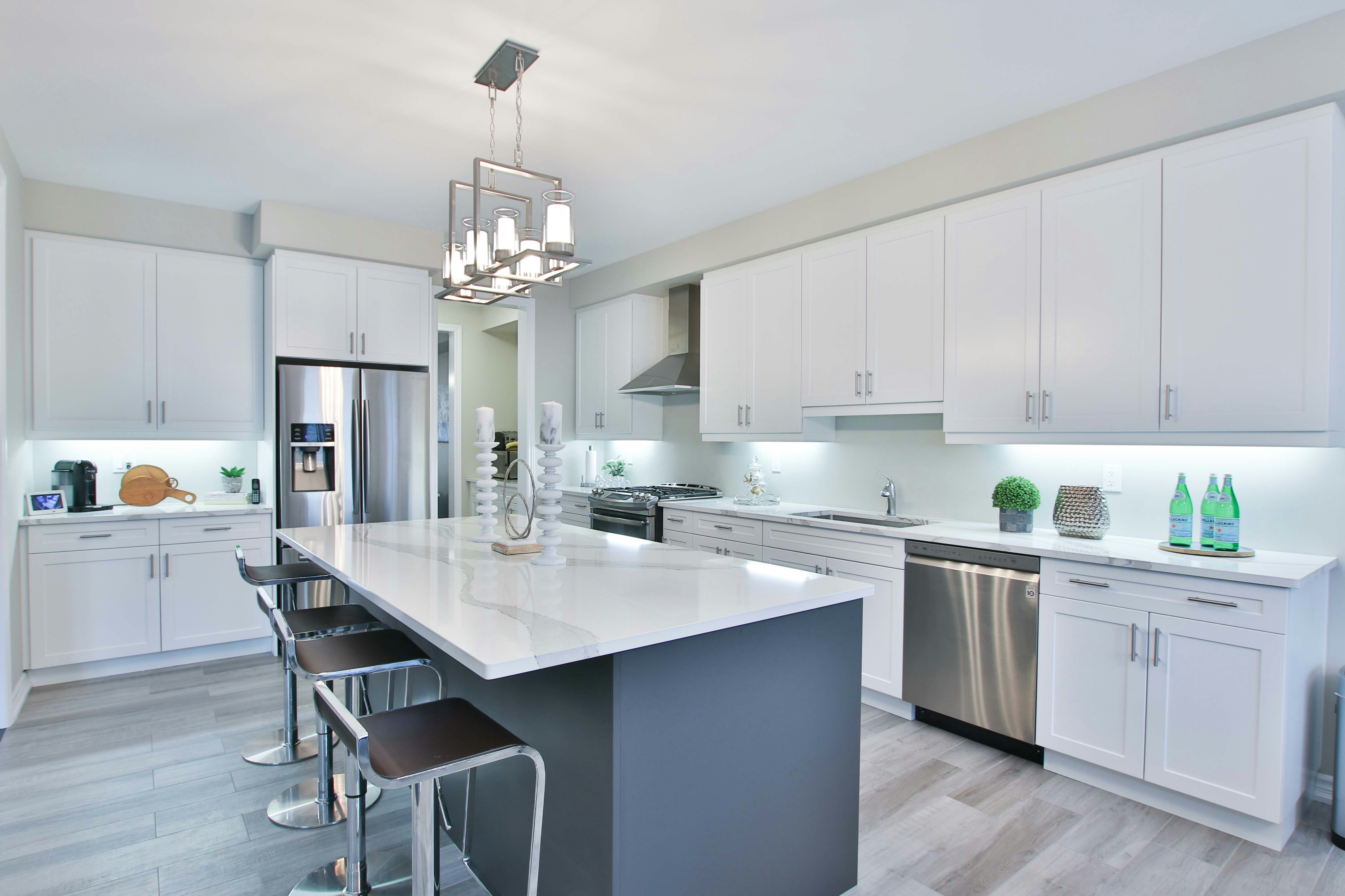 This image depicts a kitchen with elegant marble countertops showcasing light gray veining.